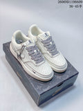 Pair of off-white low-top sneakers with patterned laces displayed on a shoebox