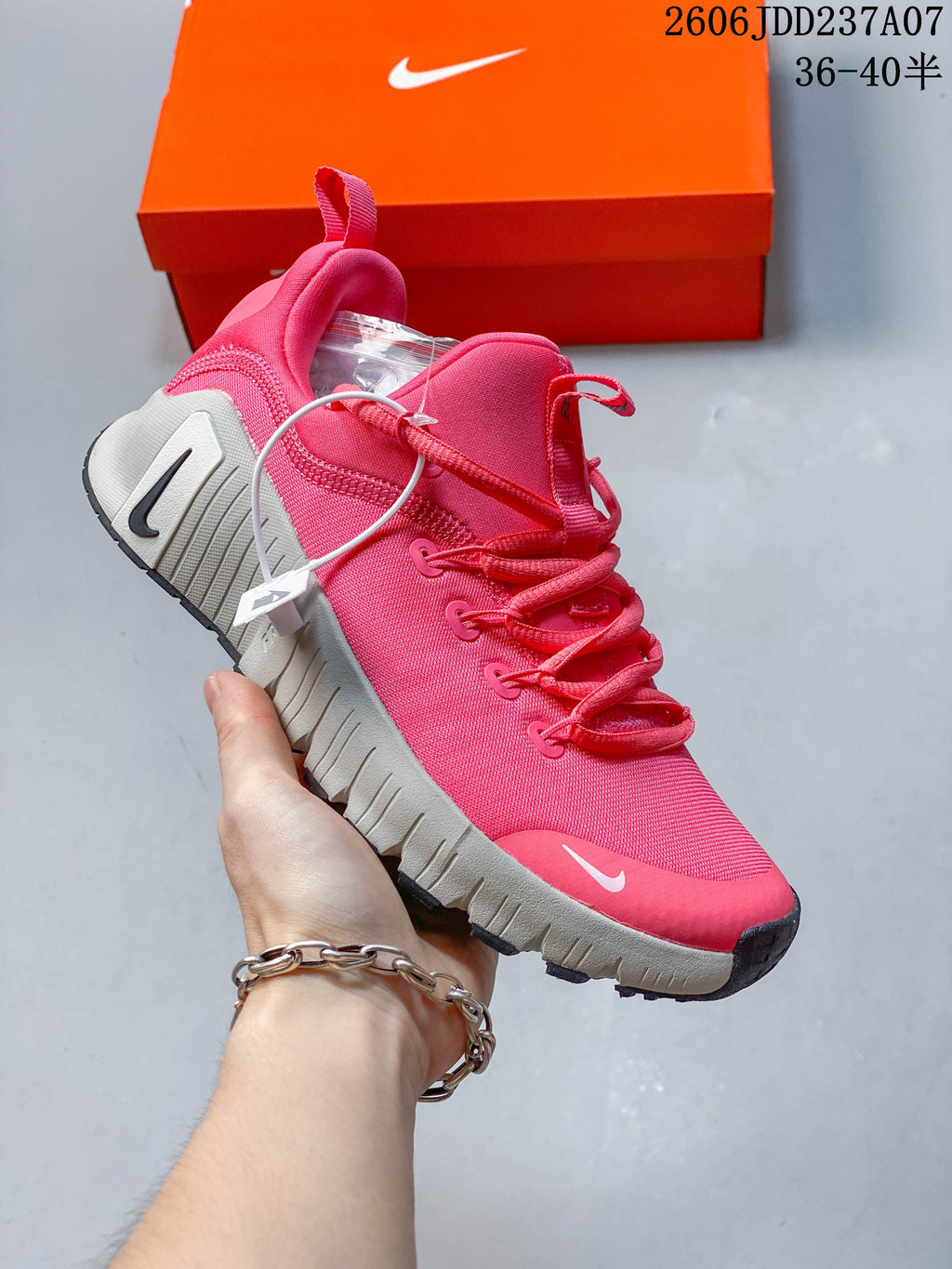 Angled side view of a pink shoe with heel and tongue pull tabs.