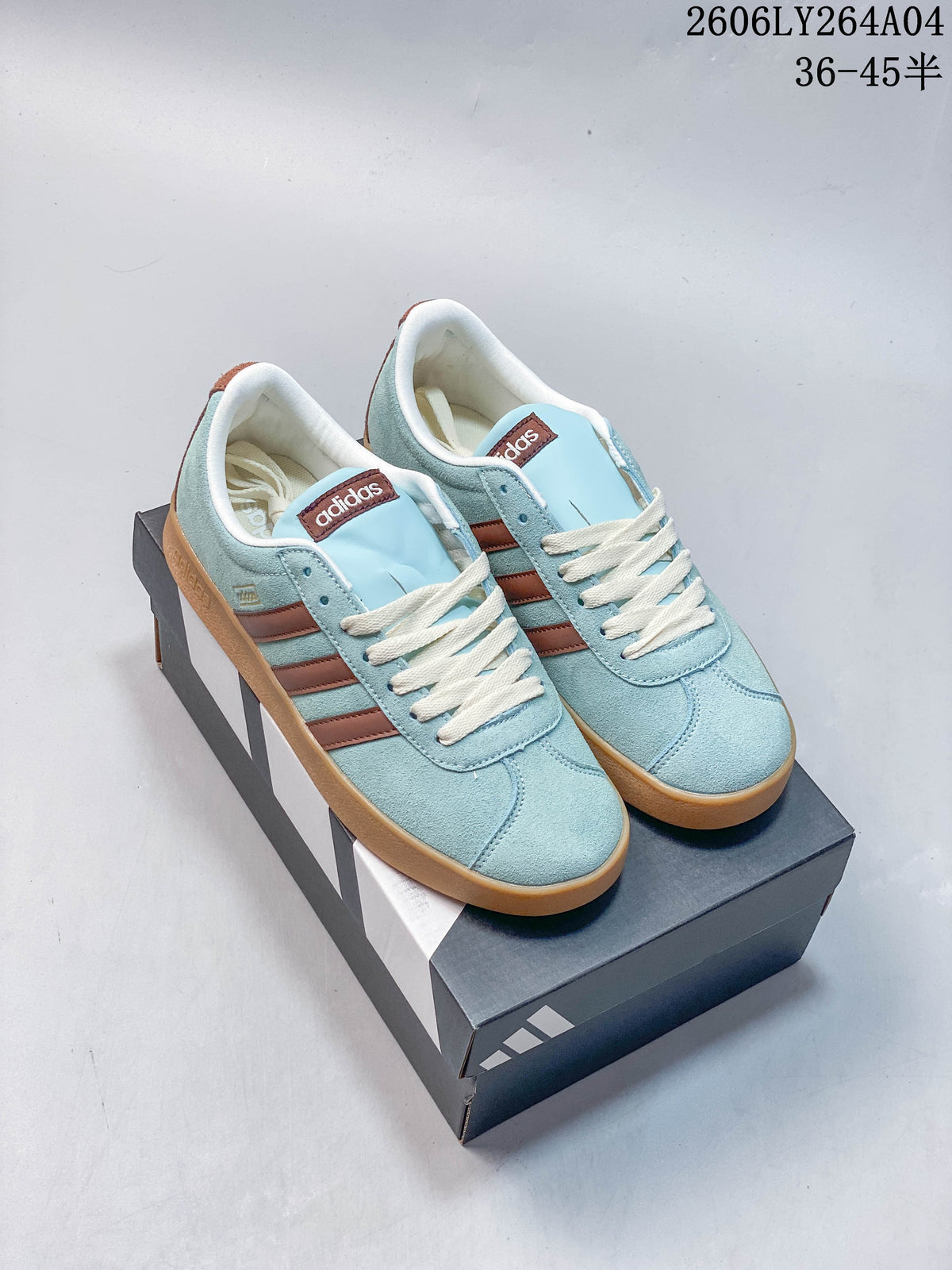 Pair of light blue adidas VL Court Classic low-top sneakers with brown stripes, cream laces, and gum-colored soles