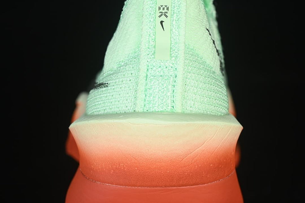 Rear view showing the mint heel and coral-orange sole