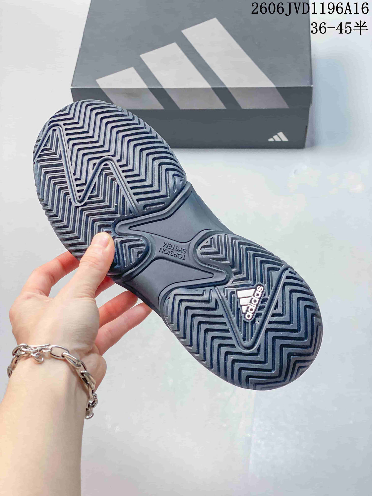 Close-up of the patterned outsole on a dark grey tennis shoe