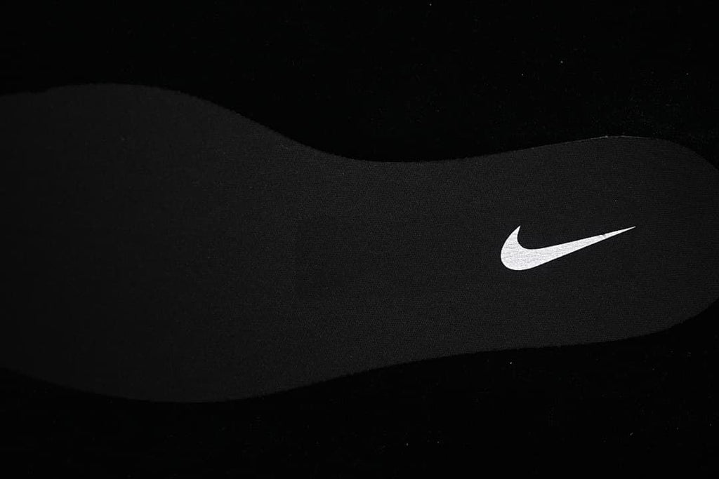 Black shoe insole with a white Swoosh mark.