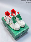 Pair of white low-top sneakers with green laces, green and red accents, and a green presentation box