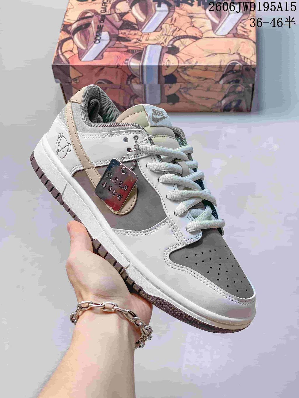 Nike SB Zoom Dunk Low sneaker in gray and white with dark laces and a contrasting outsole.