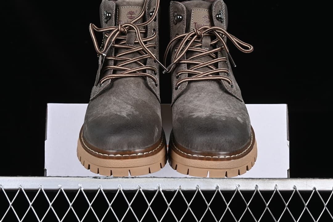 Front view of the pair of gray lace-up boots.