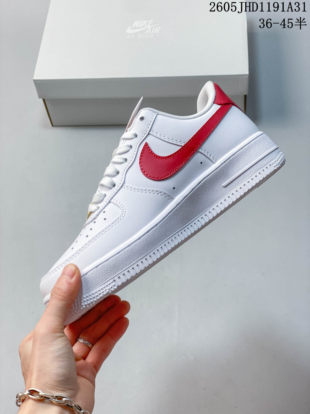Side profile of the white low-top sneaker with red Swoosh accent