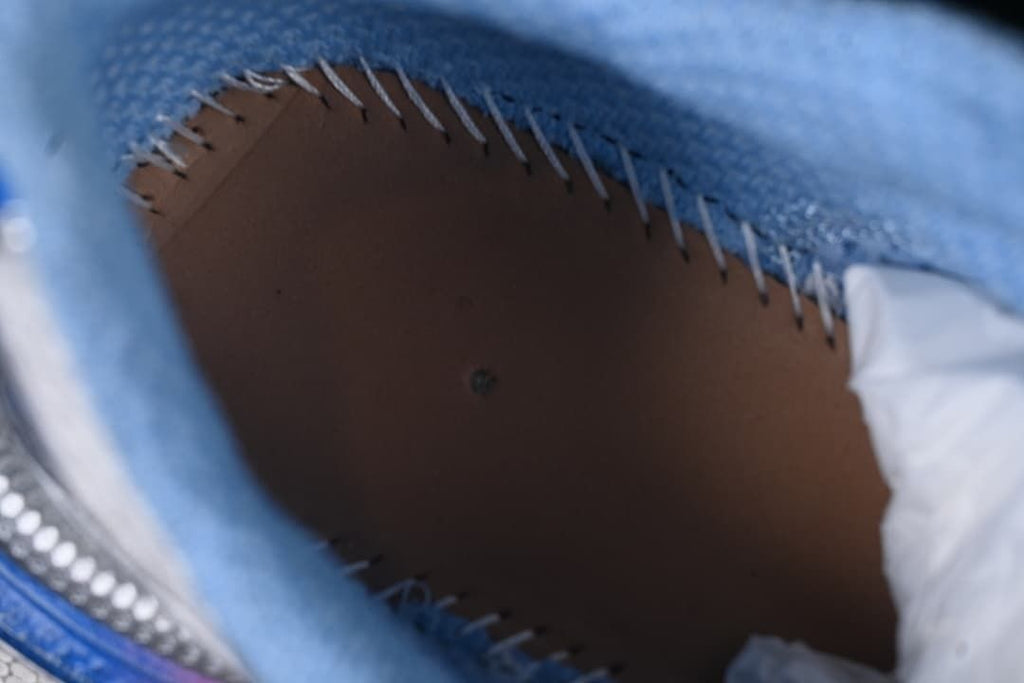 Close-up inside the sneaker showing stitching and blue lining