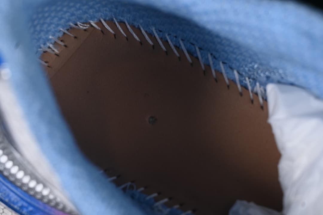 Close-up inside the sneaker showing stitching and blue lining