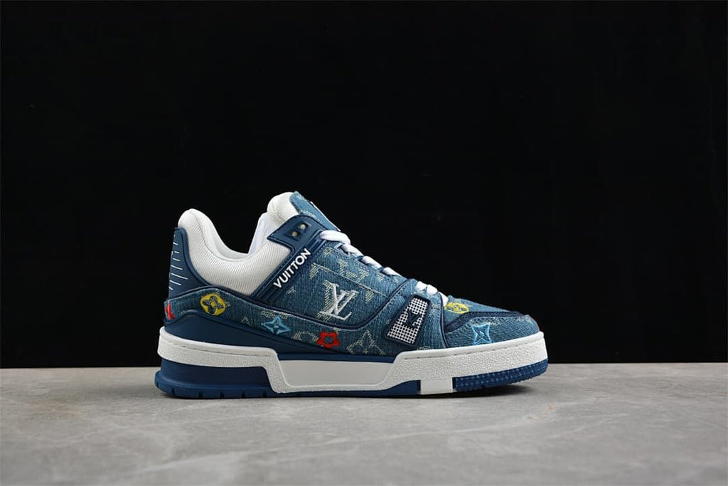 Side profile of a blue patterned sneaker with white midsole and multicolor details.