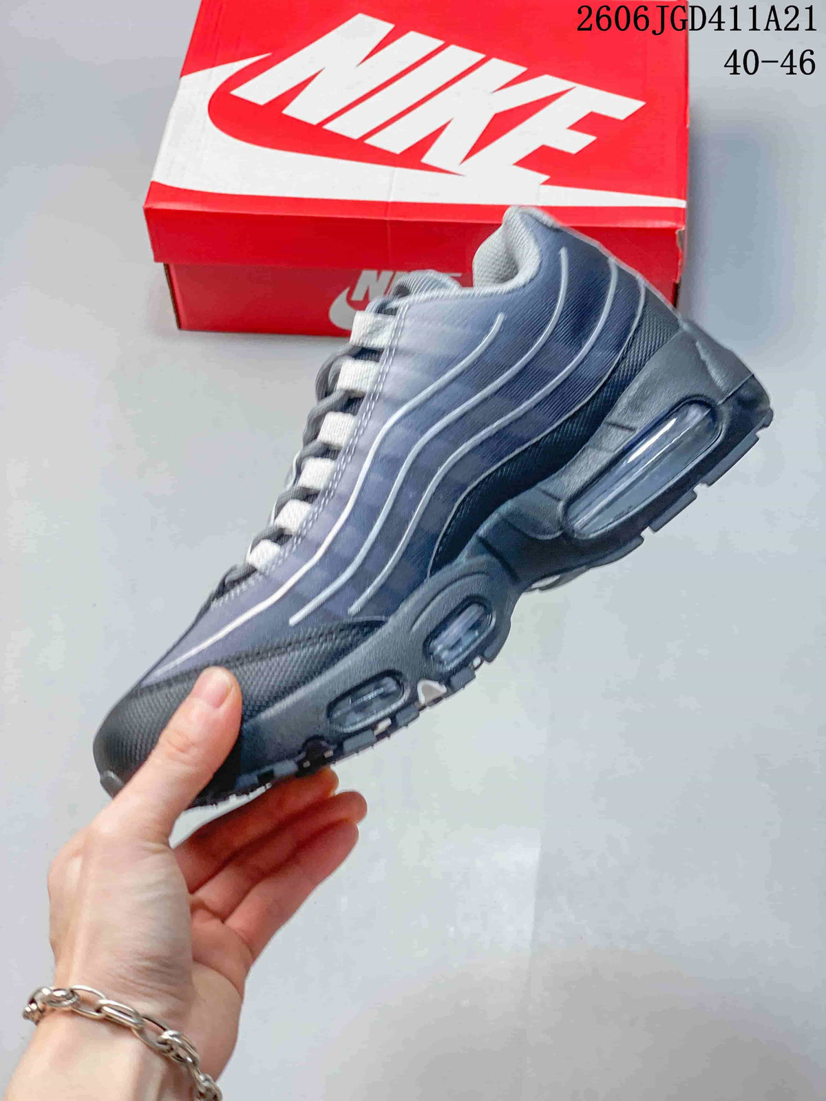 Side profile of a grey Nike Air Max 95 sneaker with visible Air units
