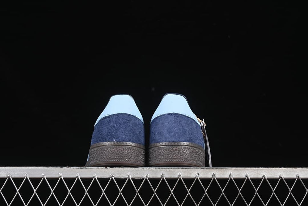 Rear view of both sneakers showing pale heel tabs