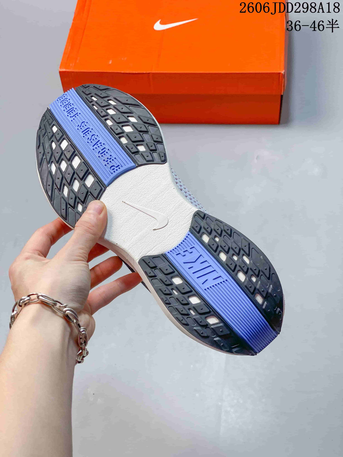 Underside view showing the patterned outsole and blue center sections