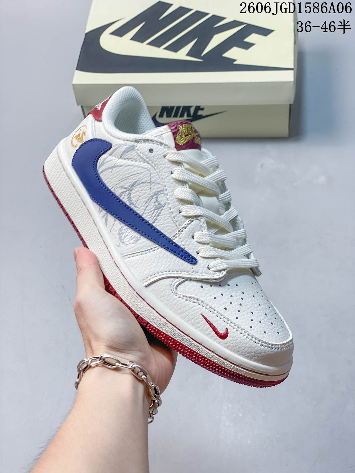 Close view of a white low-top sneaker with a navy Swoosh and red outsole details.
