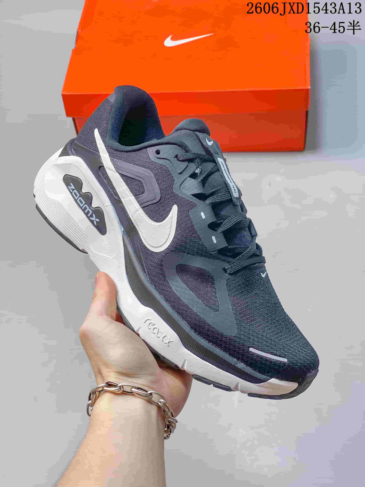 Angled side view highlighting the charcoal upper, white Swoosh, and midsole.