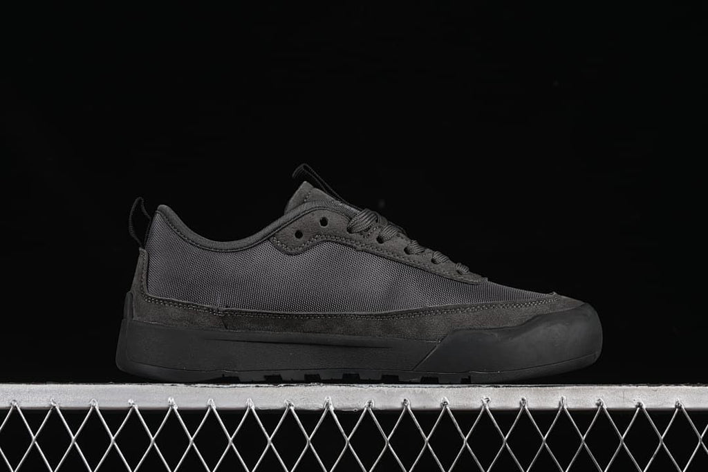 Side profile of a charcoal grey low-top sneaker