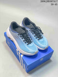 Pair of blue and white adidas Purechill V2 sneakers with dark laces on a blue shoebox