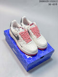 Pair of off-white low-top sneakers with gray swooshes, red patterned details and red-and-white laces