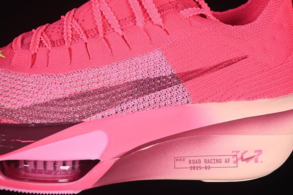 Close-up of the pink upper, dark Swoosh and sculpted midsole