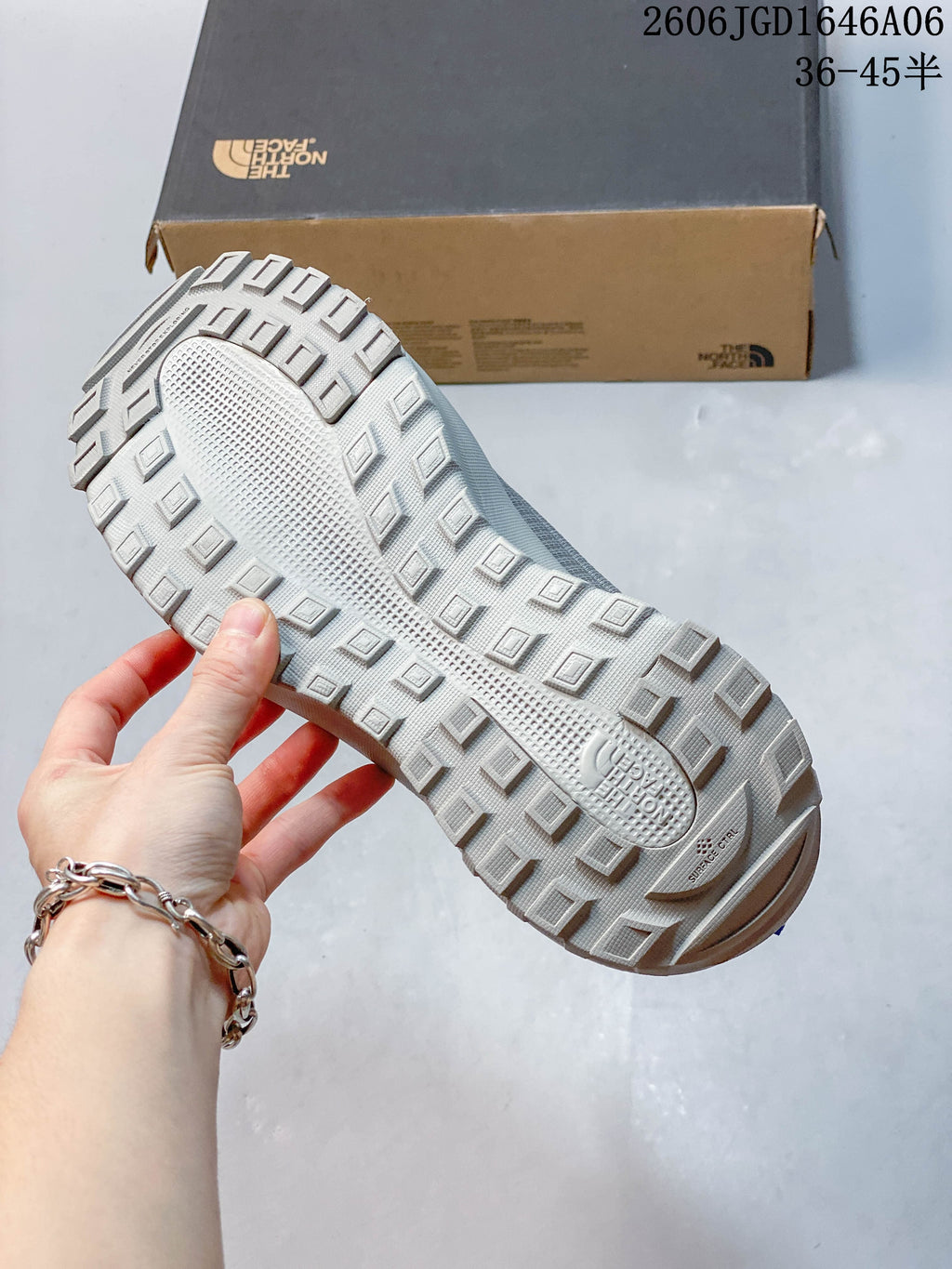Close-up of the shoes' lugged outsole and tread.