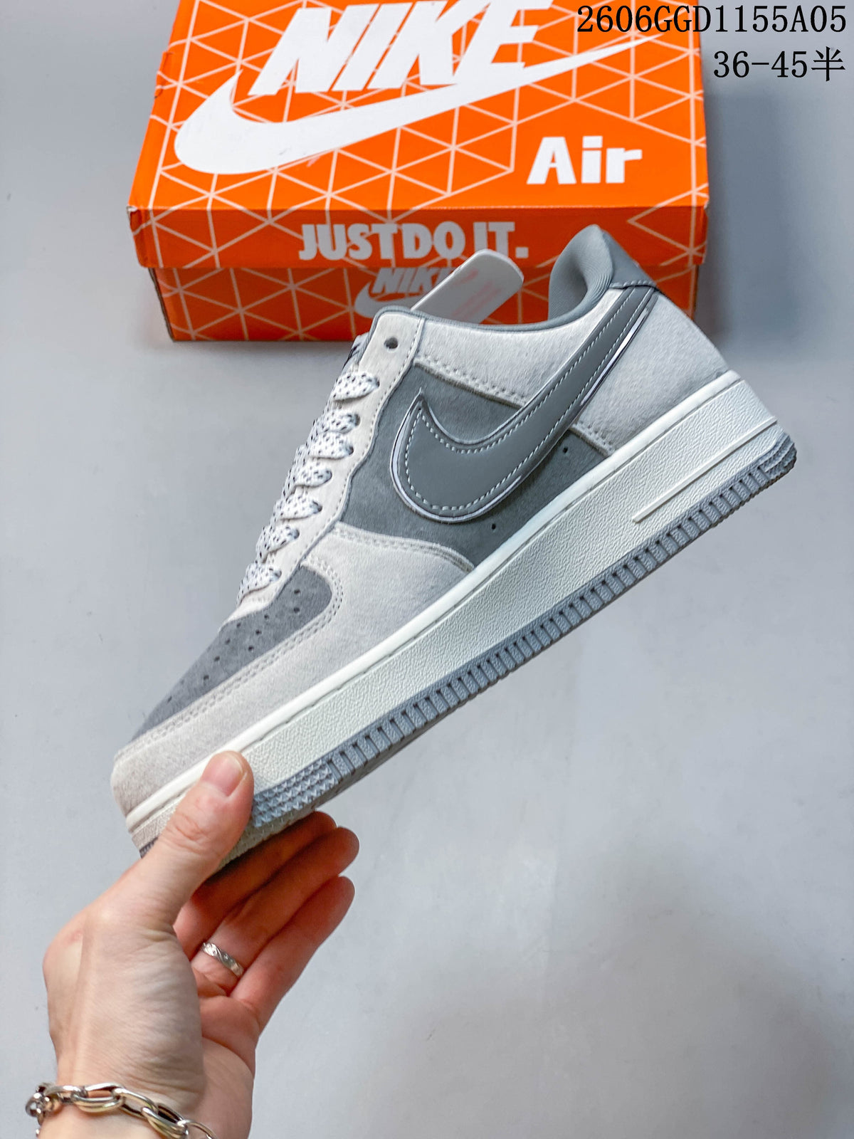 Side view of a grey and white Nike Air Force 1 low-top sneaker