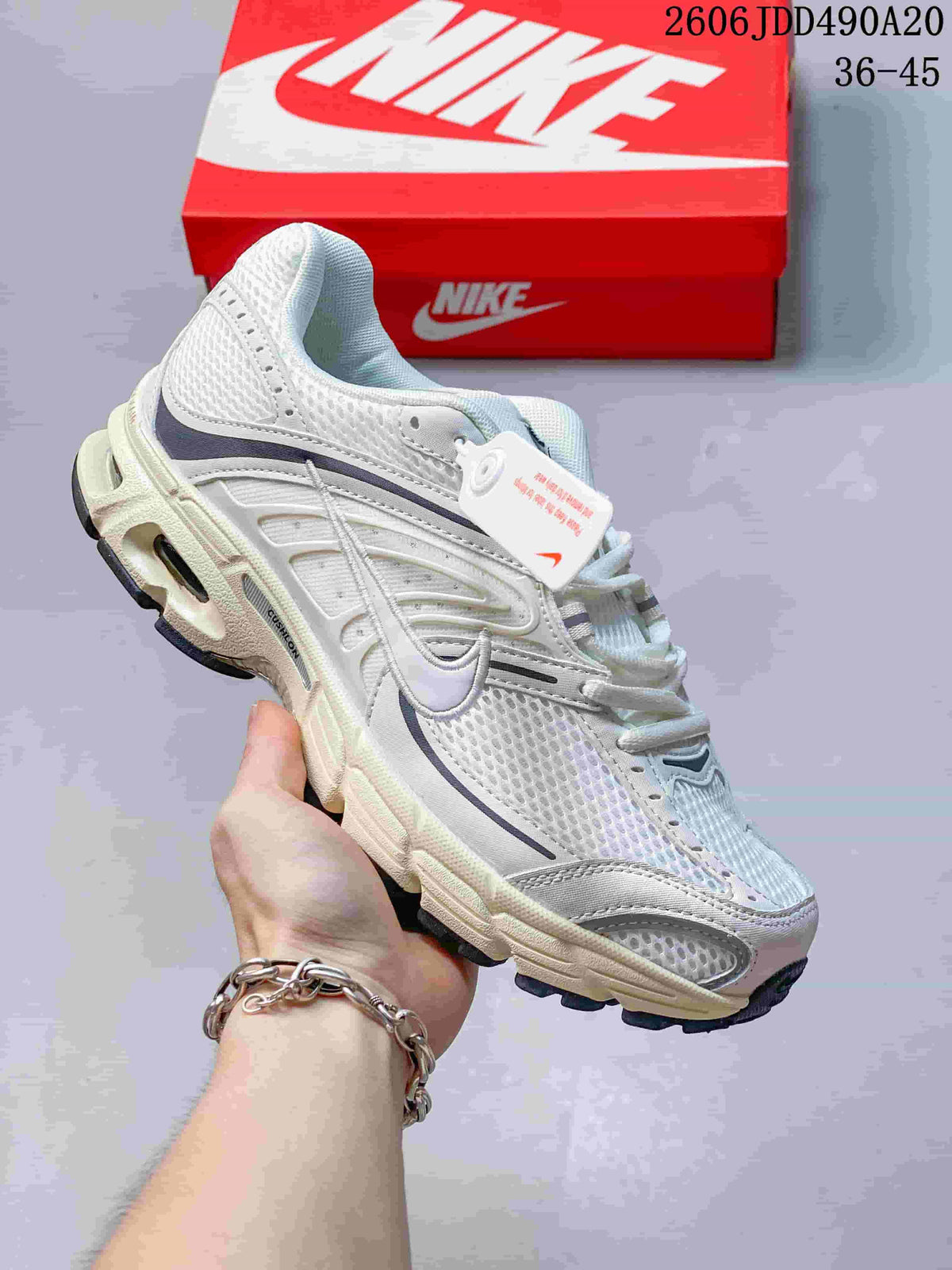 White Nike Air Max Moto 2K sneaker with gray and pale green accents