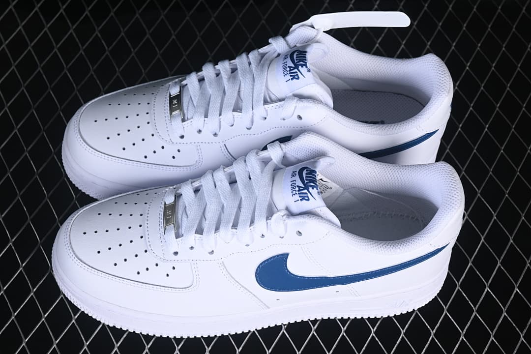 Pair of white and navy Nike Air Force 1 ’07 Low sneakers viewed from above