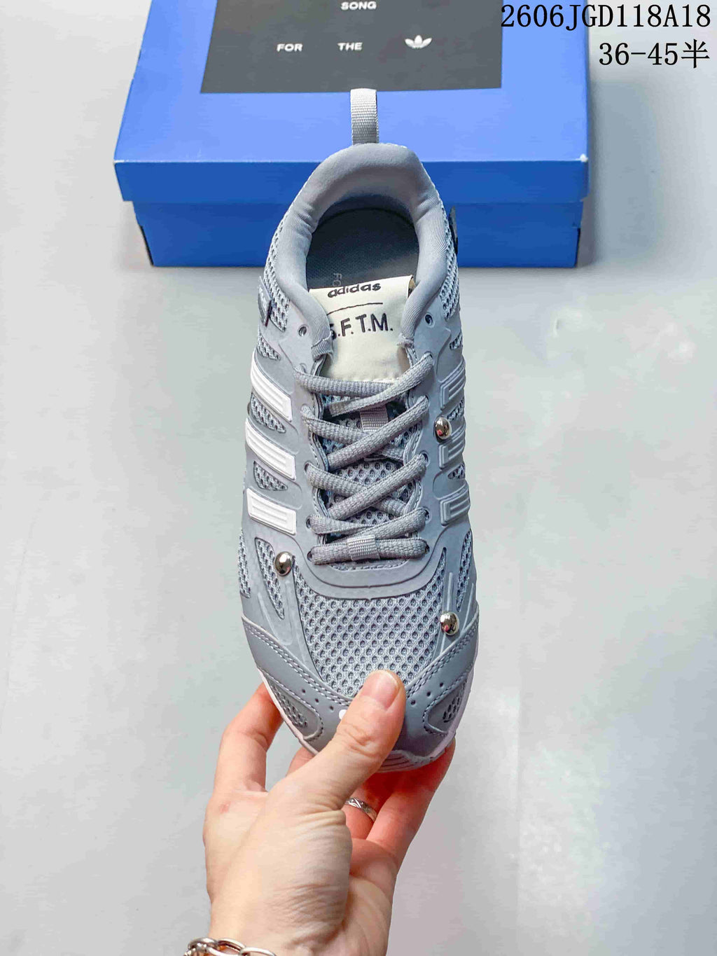 Top view of a grey lace-up sneaker with mesh-patterned panels