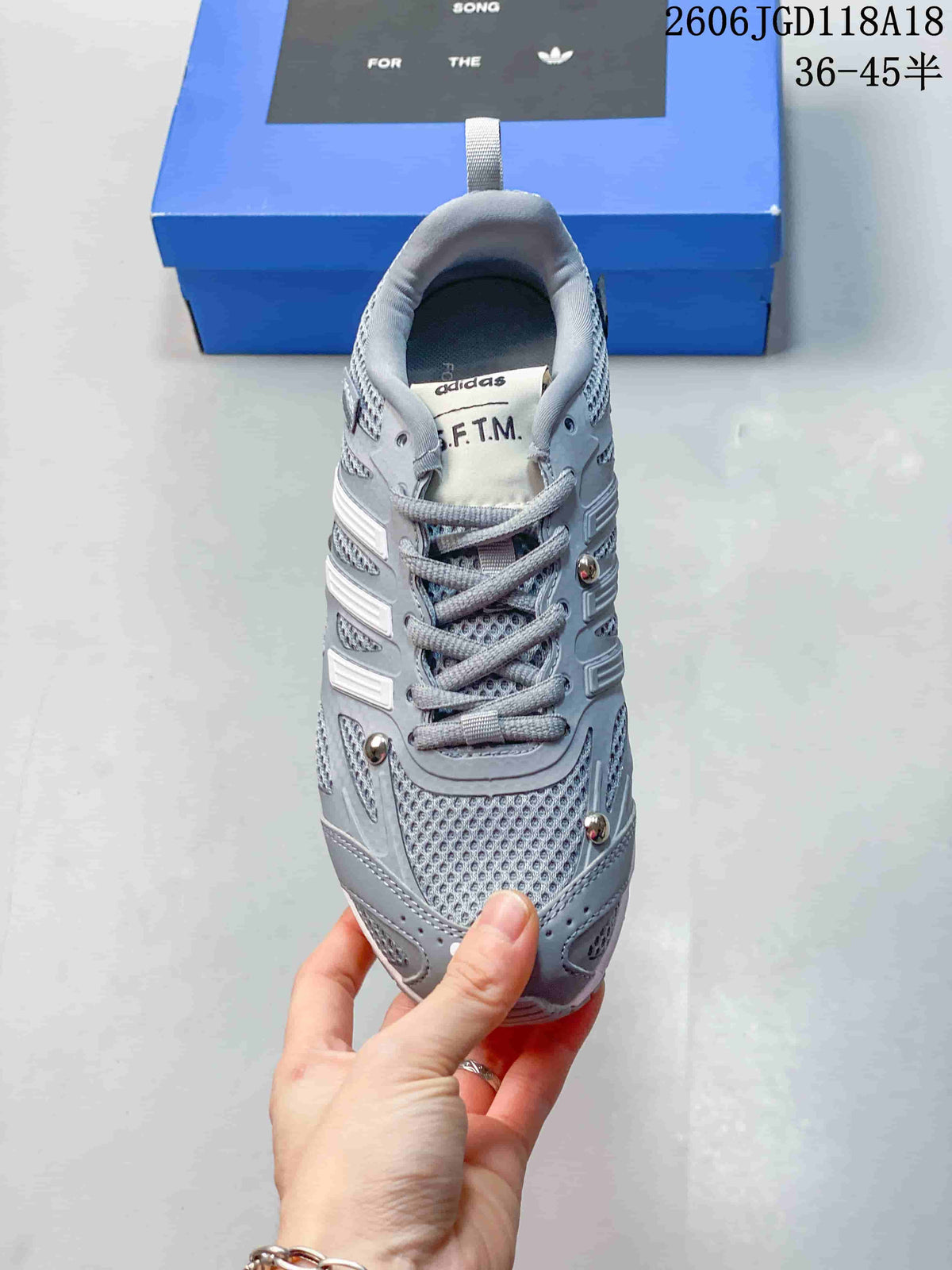 Top view of a grey lace-up sneaker with mesh-patterned panels