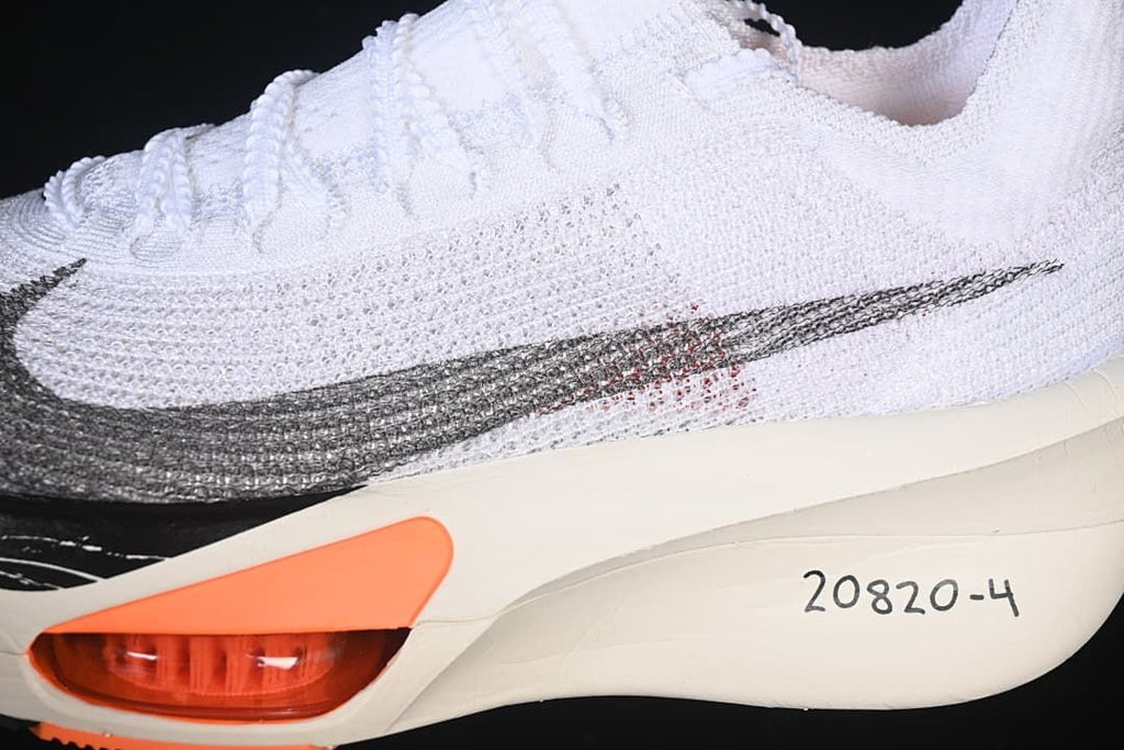 Close-up of the dark side Swoosh and orange sole detail