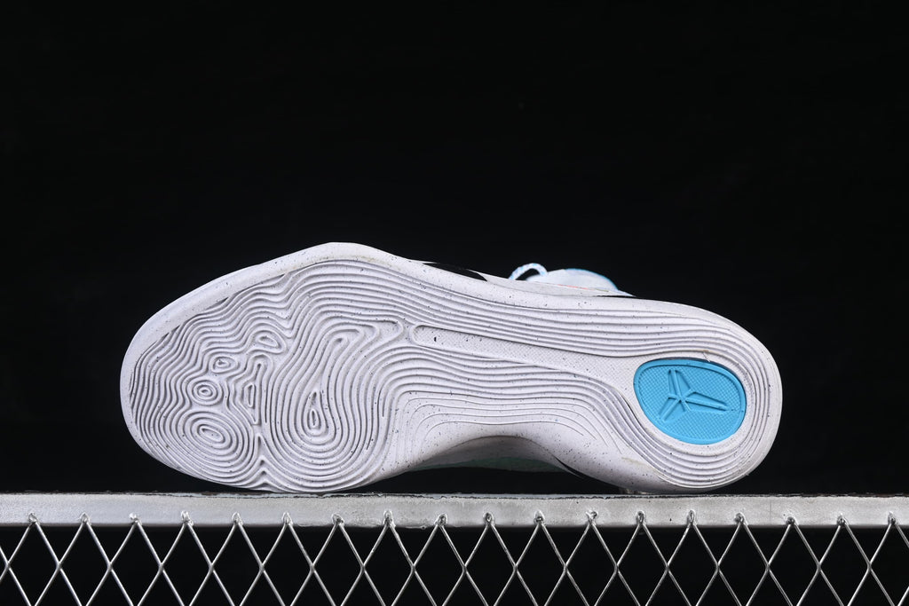 Underside view of the shoe with concentric traction patterns and a blue heel detail.