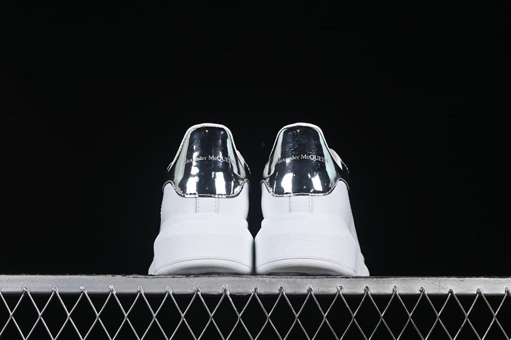 Rear view of both sneakers showing the reflective heel panels