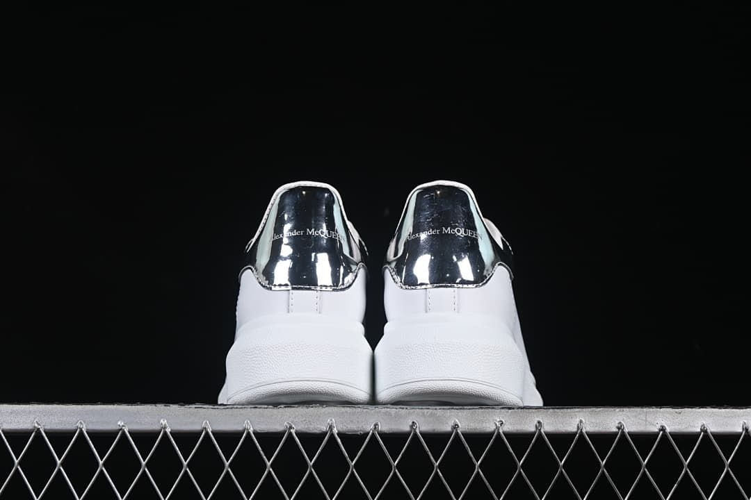 Rear view of both sneakers showing the reflective heel panels
