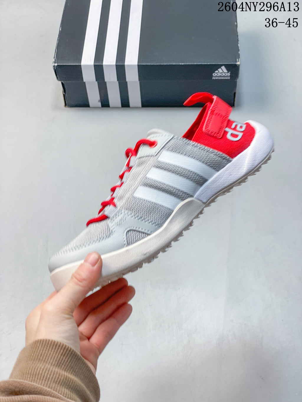 Side view of the gray adidas TERREX shoe with red laces and heel accents