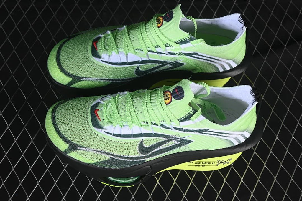 Pair of green and black racing shoes shown from above