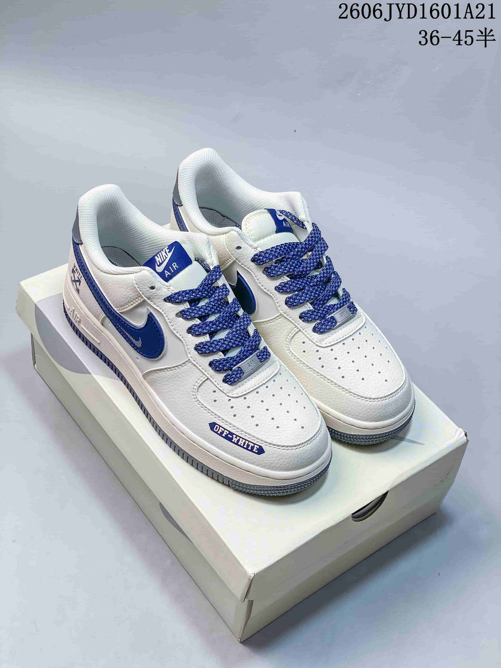 Pair of white and blue Nike Air Force 1 low-top sneakers with blue laces