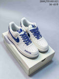 Pair of white and blue Nike Air Force 1 low-top sneakers with blue laces