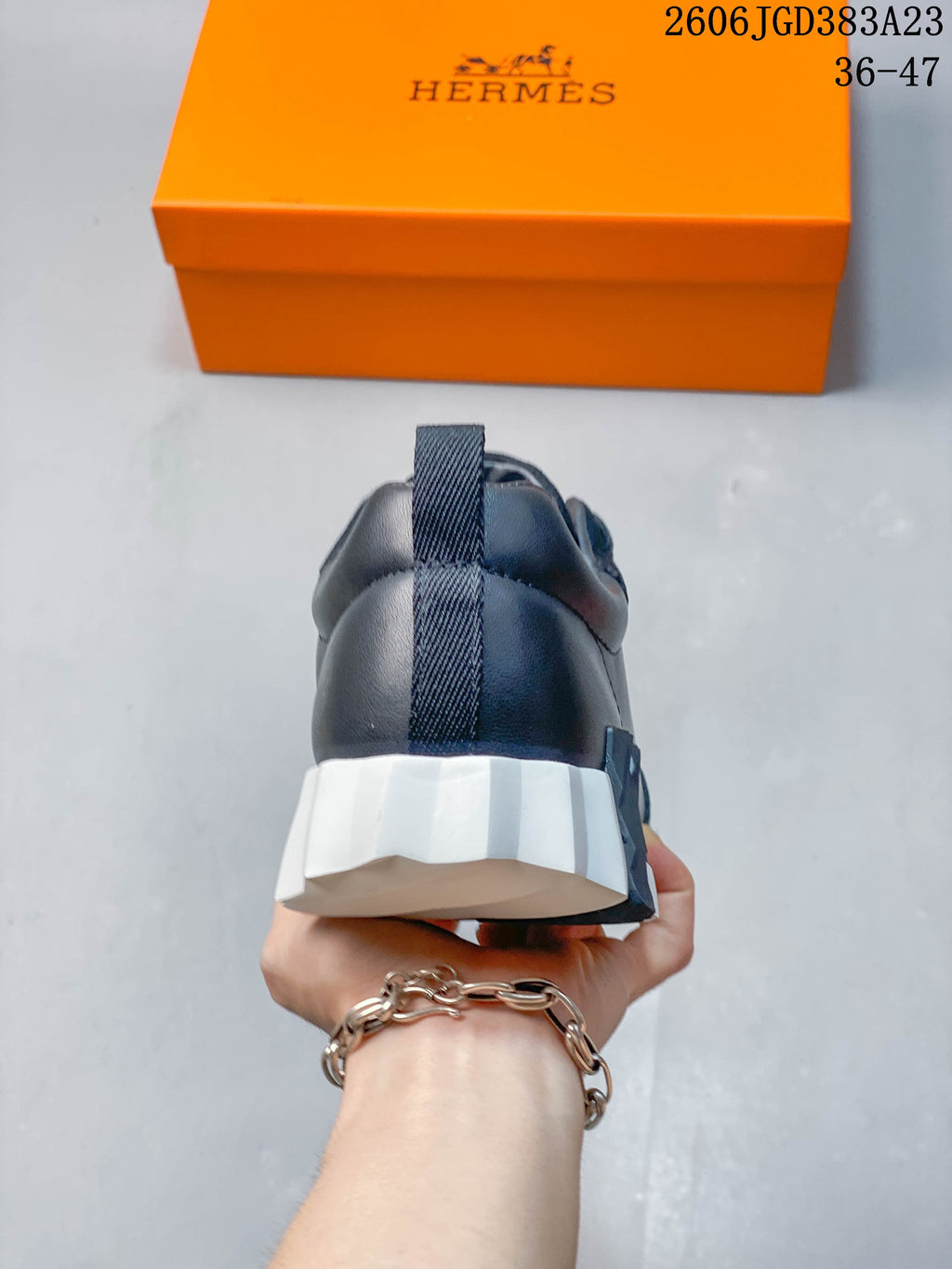 Rear view of a navy sneaker with heel pull tab and white ridged sole
