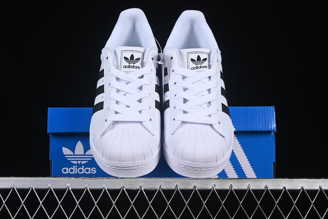 Front view of the pair showing shell toes, laces and black stripe details