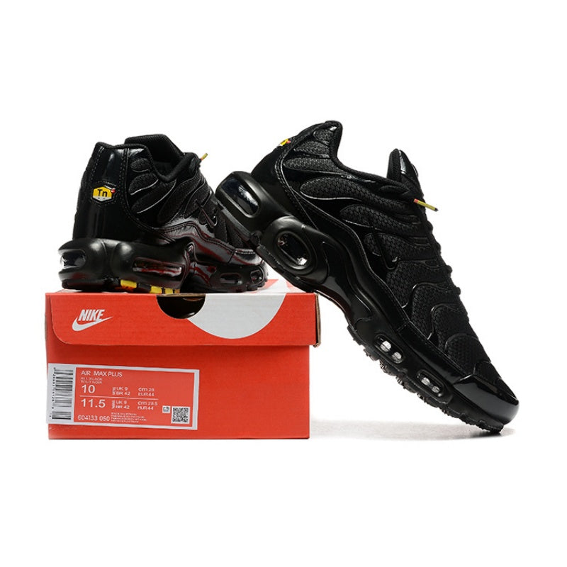 Black Nike Air Max Plus sneakers displayed with a box labeled Air Max Plus; the box shows a sample size.