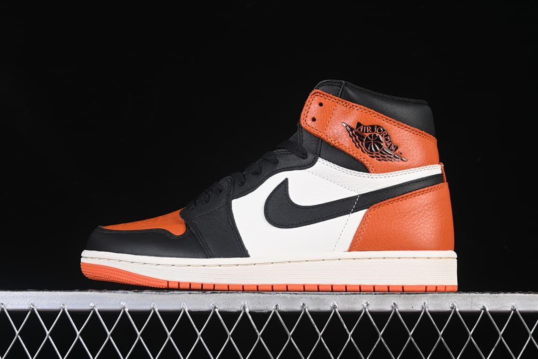 Side view of an orange, black and white Air Jordan 1 High OG high-top sneaker