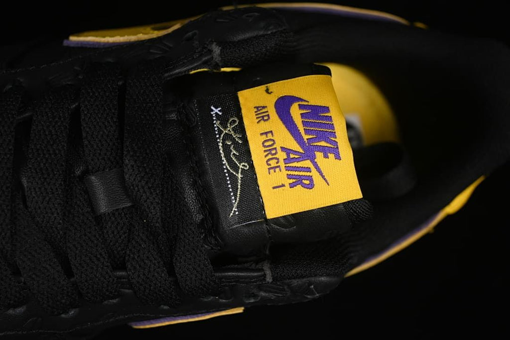Tongue detail with yellow and purple branding and a Kobe signature-style graphic.