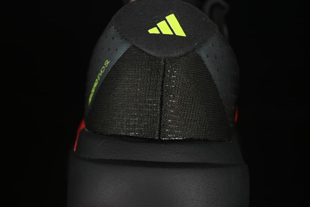 Rear view showing the heel construction and lime Adidas logo