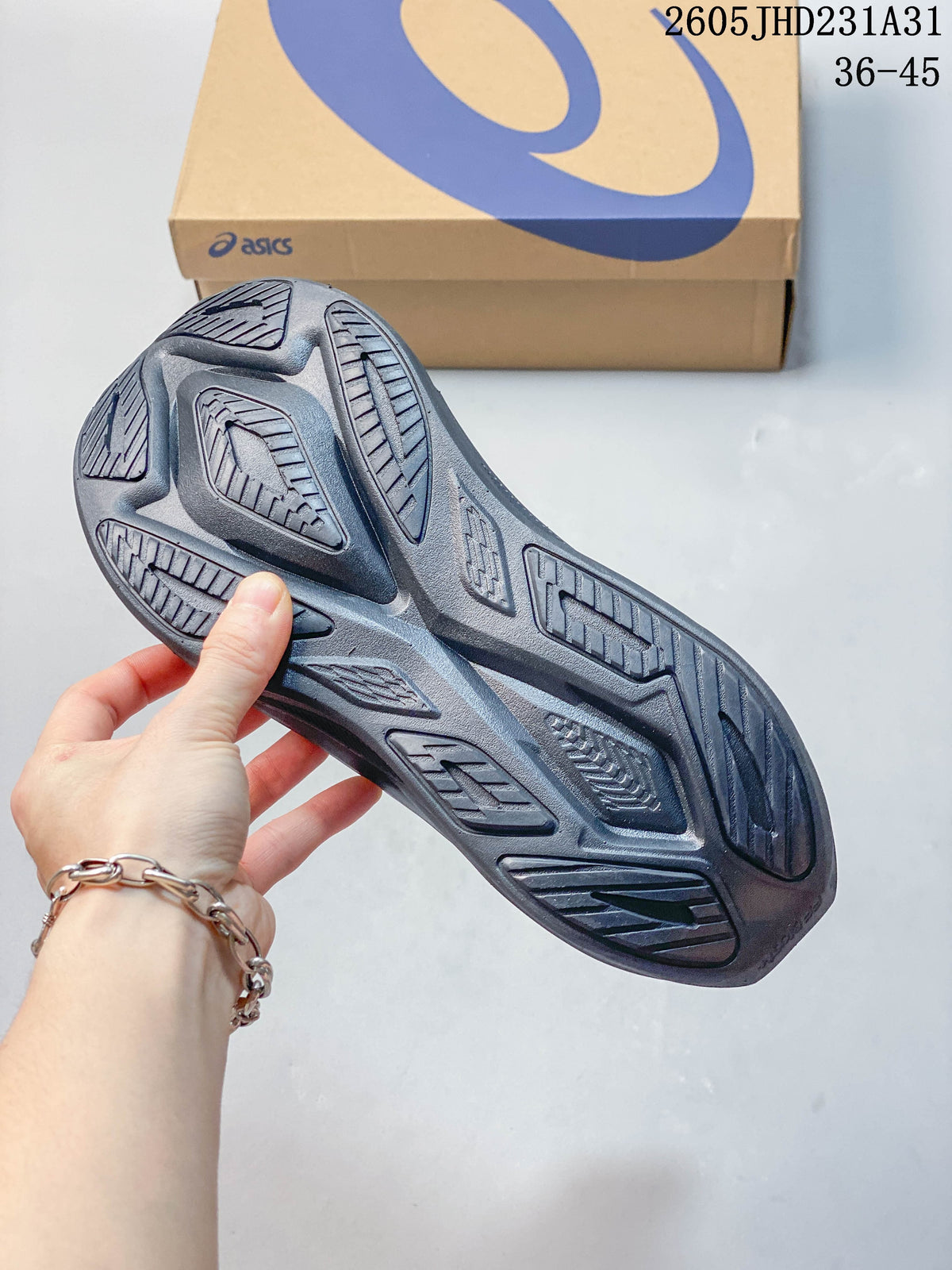 Close-up of the patterned outsole on a dark gray running shoe