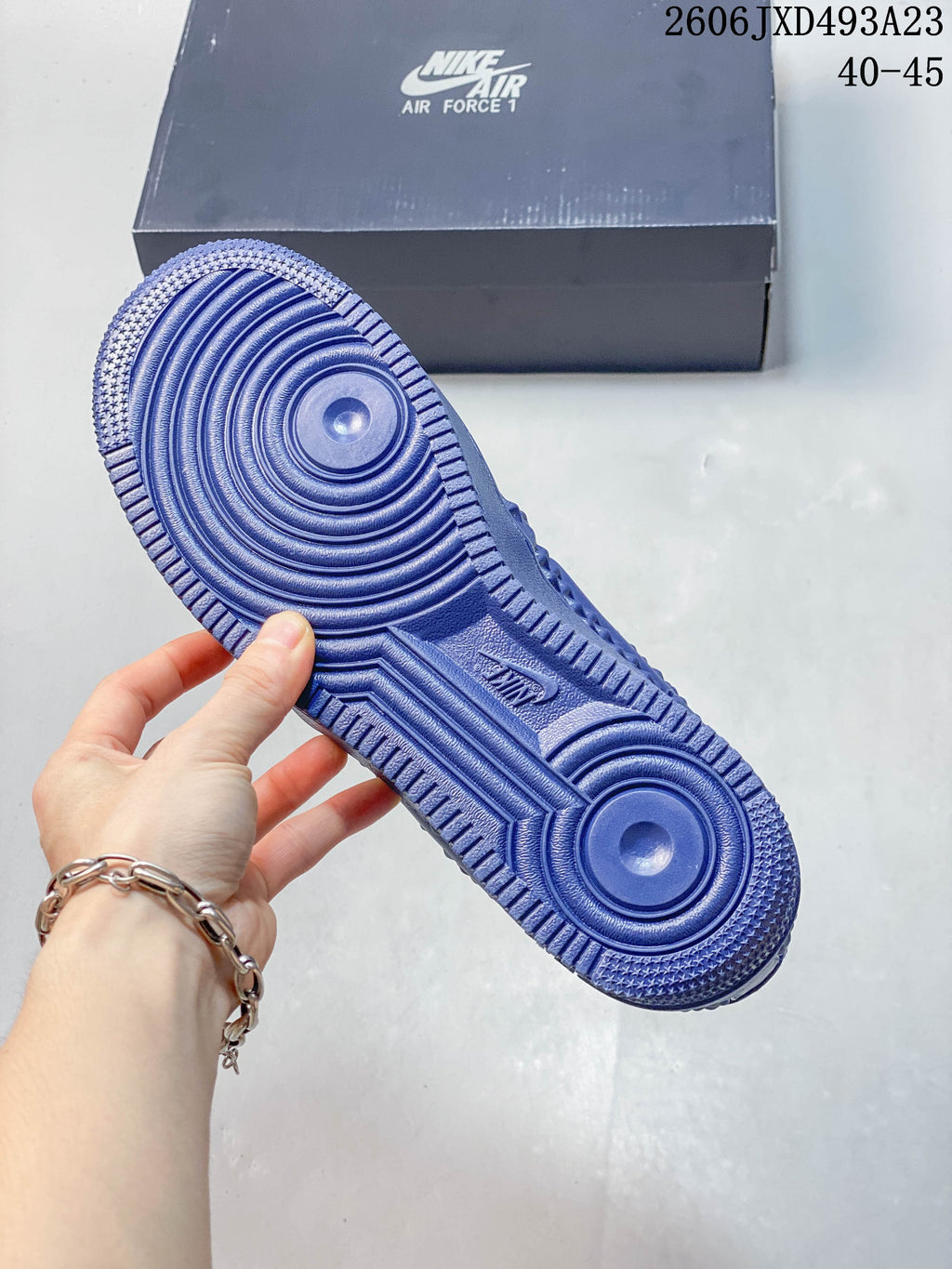 Close-up of the blue patterned outsole on a Nike Air Force 1 sneaker