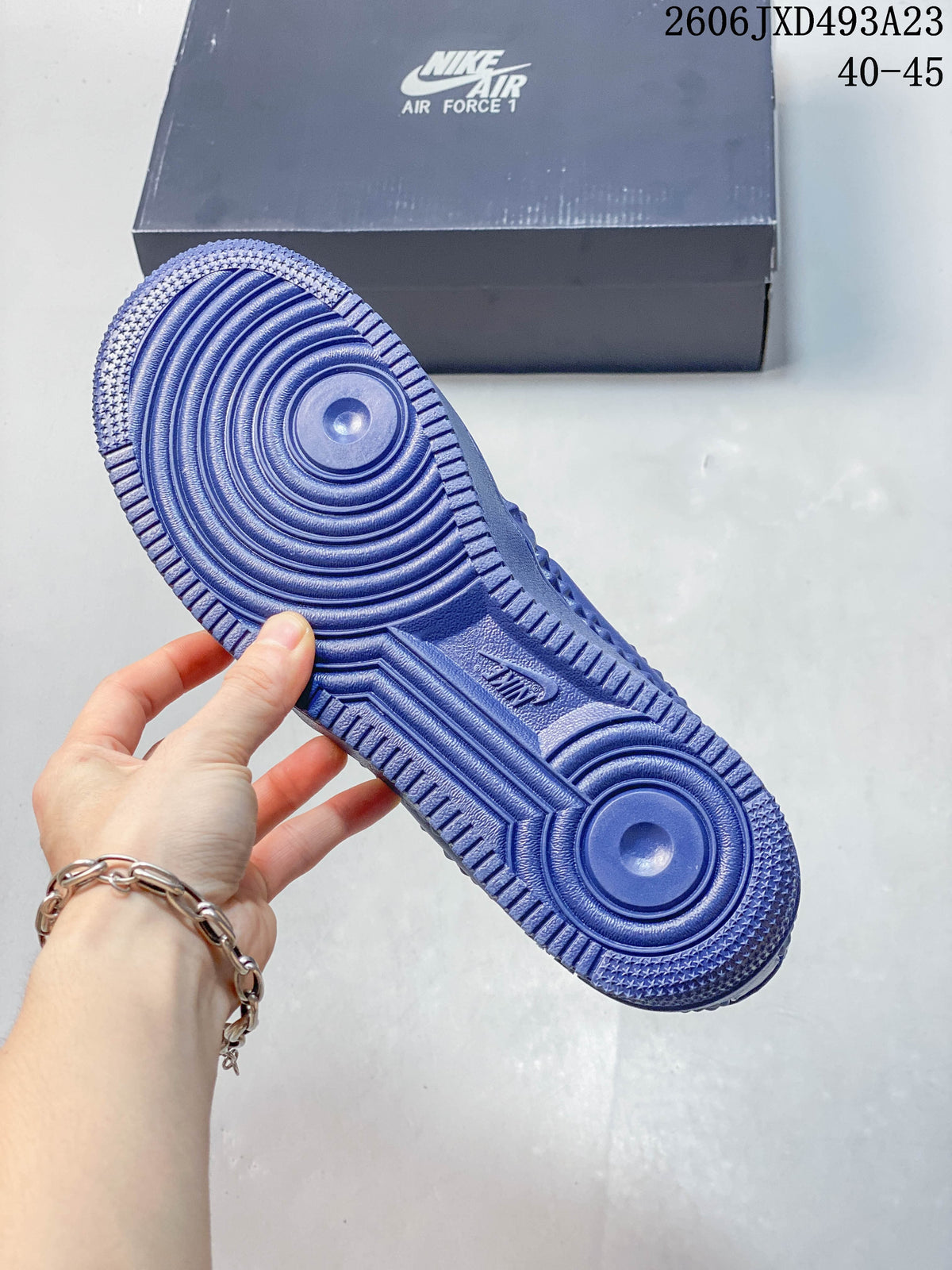 Close-up of the blue patterned outsole on a Nike Air Force 1 sneaker
