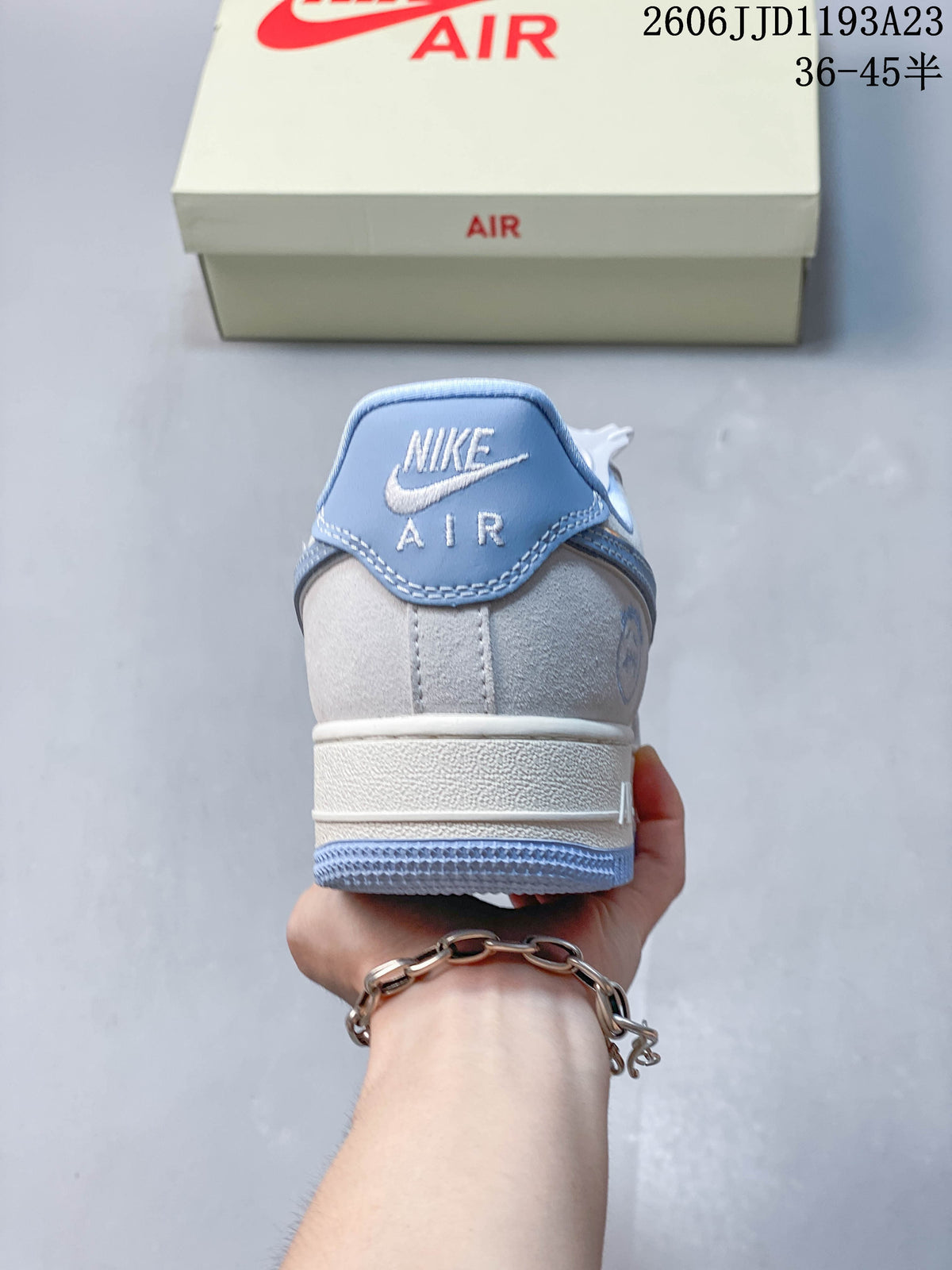 Heel view of a Nike Air Force 1 sneaker with a blue heel tab and white branding