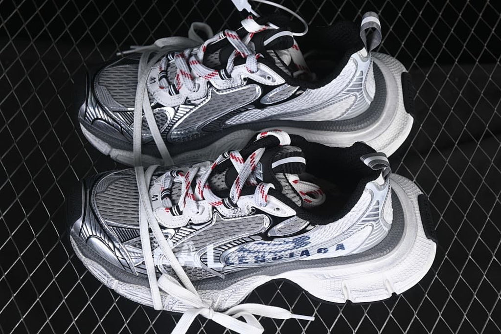 Pair of white, navy, and grey sneakers viewed from above