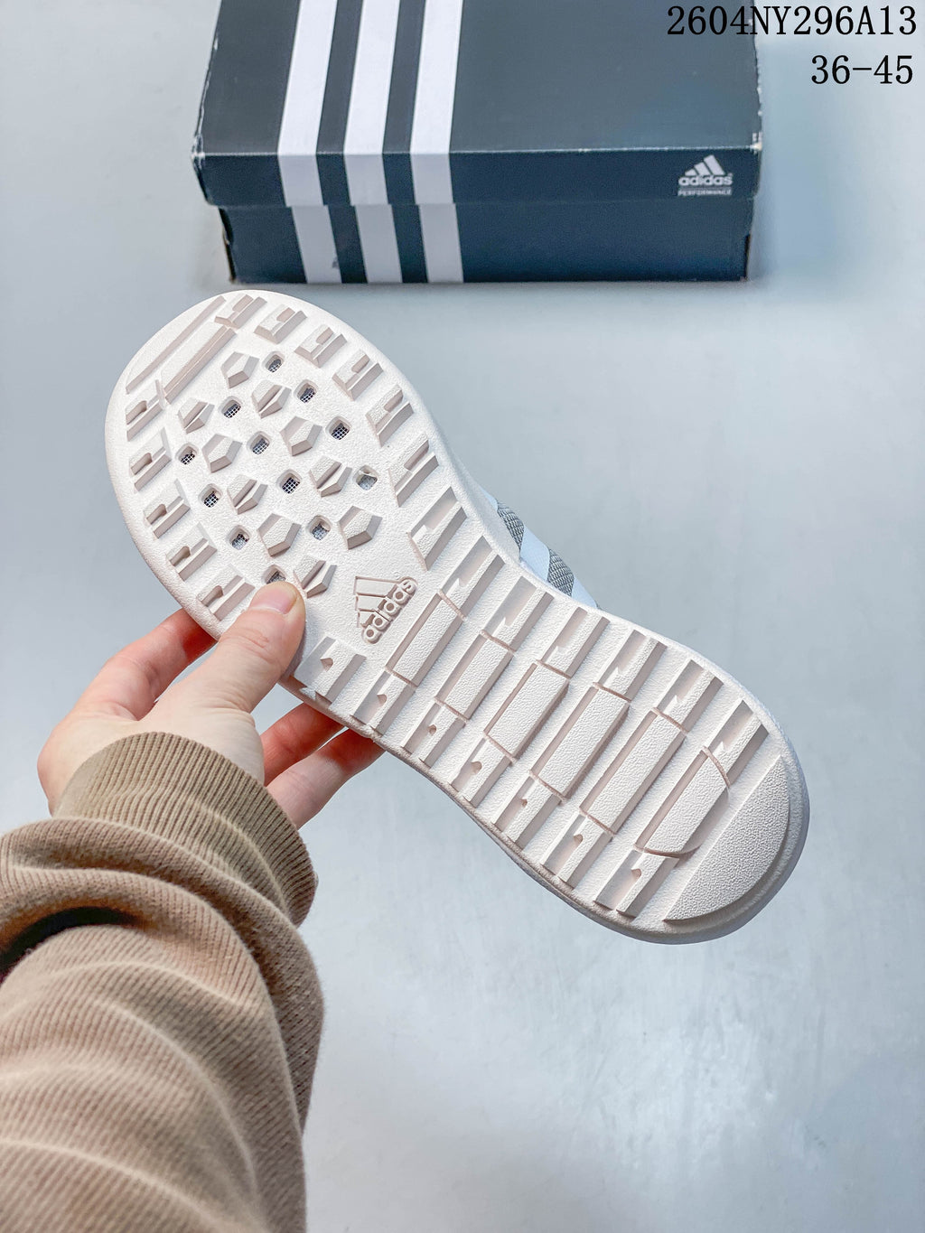 Underside of the shoe showing a light-colored patterned outsole.
