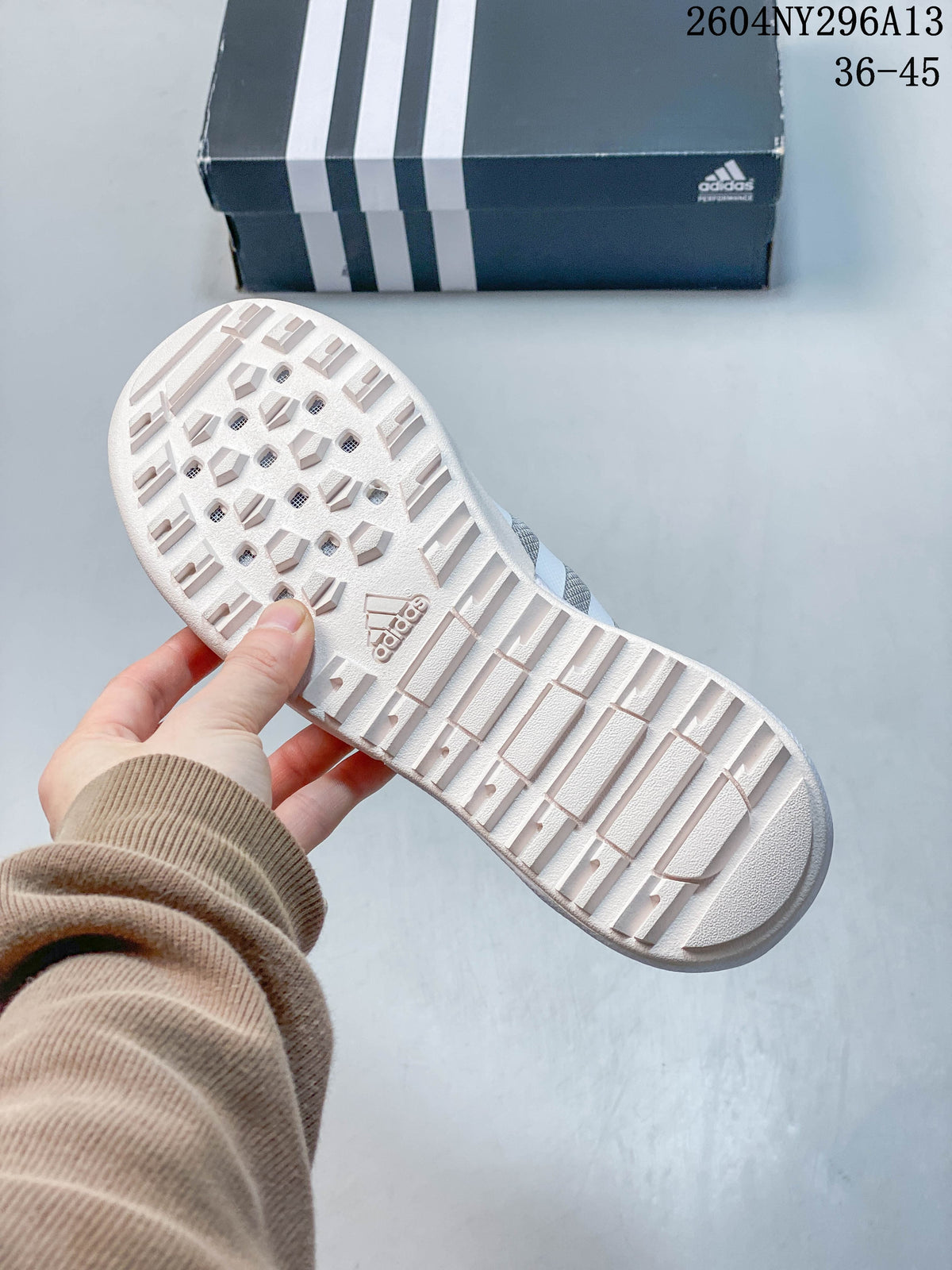 Underside of the shoe showing a light-colored patterned outsole.