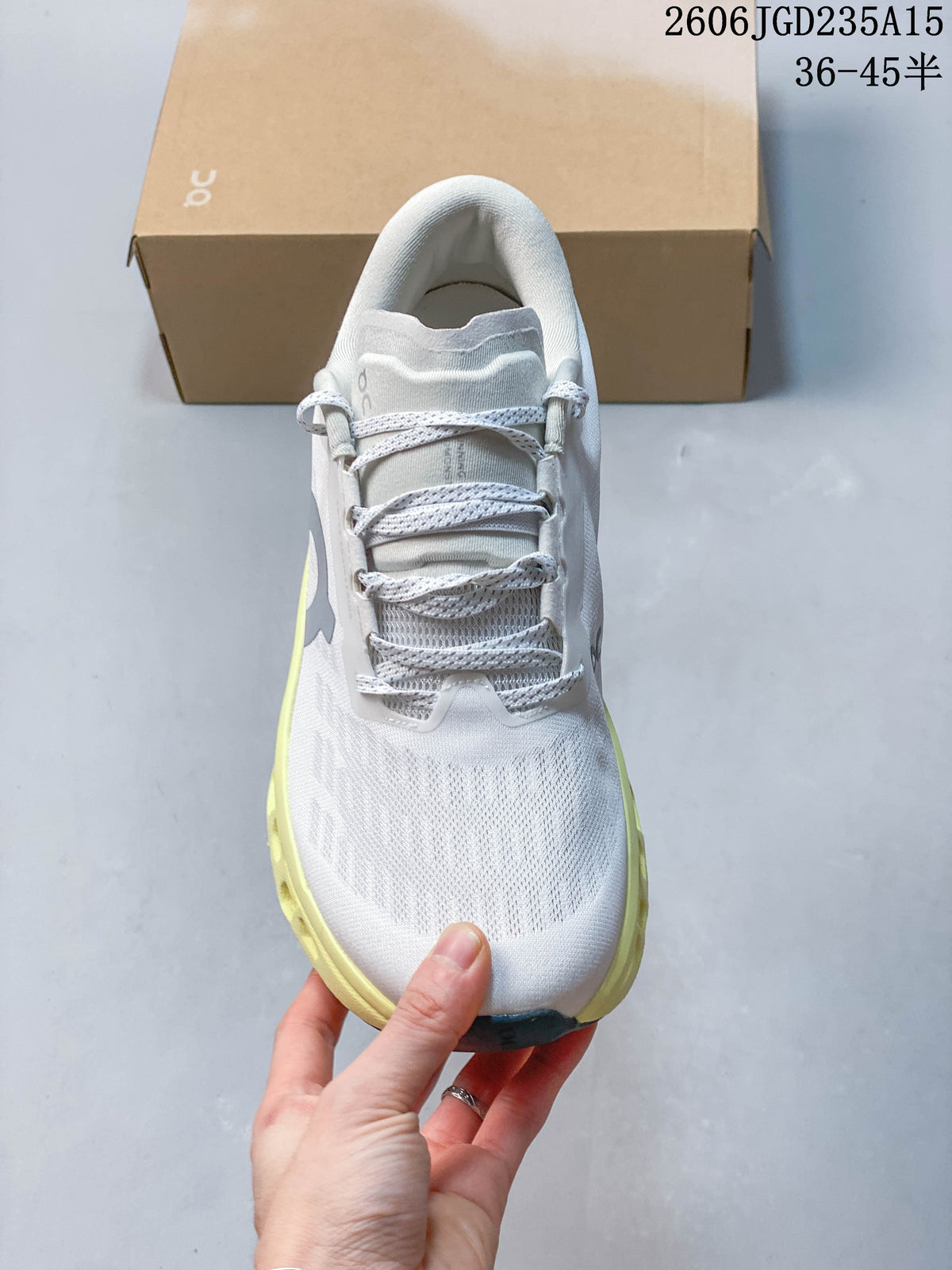 Top view of the shoe showing the white upper, tongue, and patterned laces